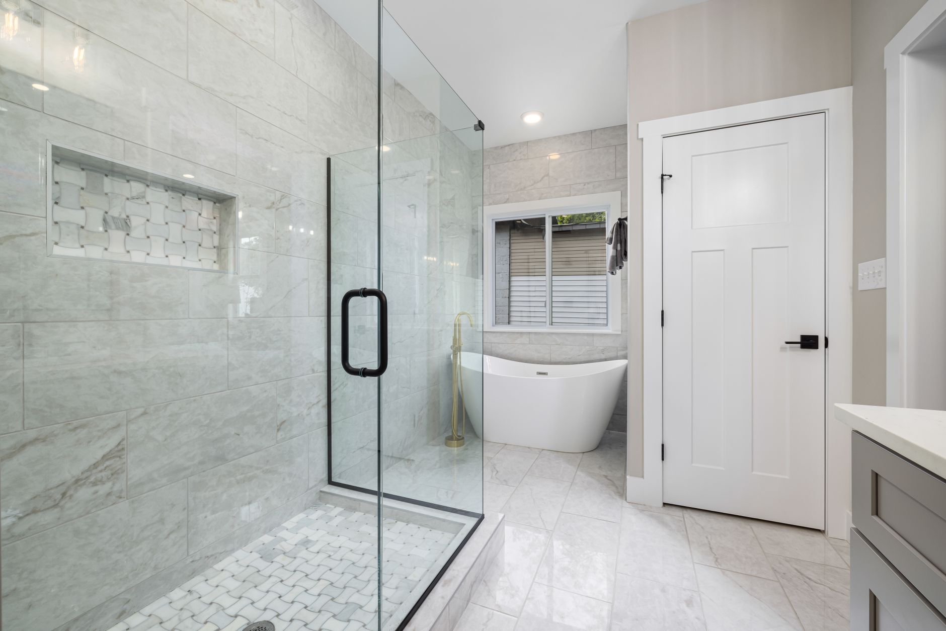 Bright modern bathroom featuring a glass shower and freestanding bathtub. Perfect for design inspiration in Riverside, CA